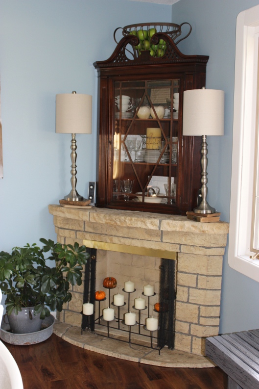 I literally took apart the corner cabinet in our former dining room, in order to use the top half in conjunction with our fireplace. Definitely outside-of-the-box-thinking, but I love how it turned out. And, I love that it cost $0!